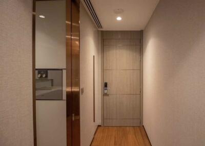 Apartment hallway with wooden floor and closed door