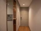 Apartment hallway with wooden floor and closed door