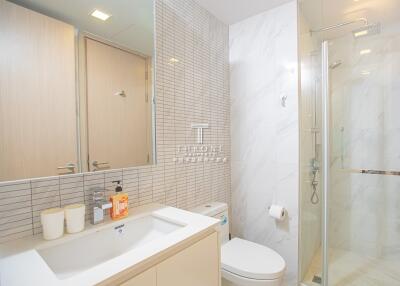 Modern bathroom with shower, sink, and toilet