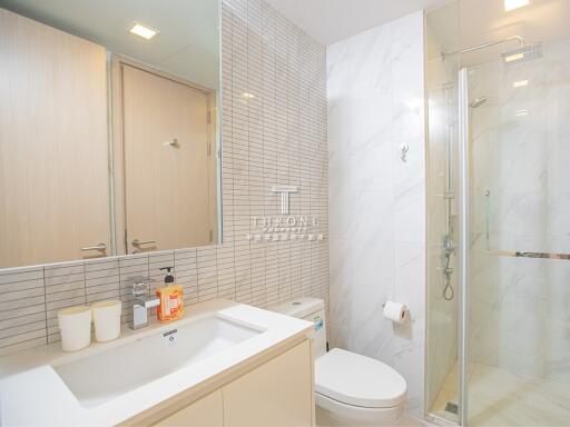 Modern bathroom with shower, sink, and toilet