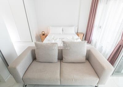 Modern bedroom with beige sofa and bed