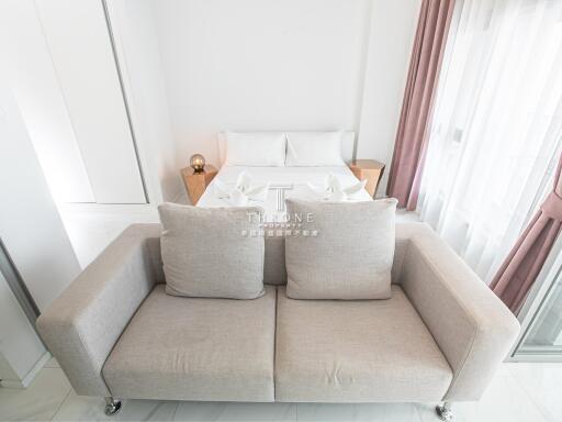 Modern bedroom with beige sofa and bed