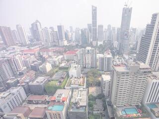 Aerial view of a city skyline with various high-rise buildings and residential areas