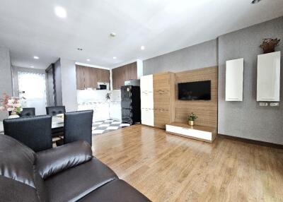 Modern living room with open kitchen and dining area