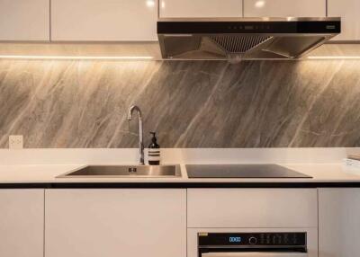 Modern kitchen with stainless steel sink and stovetop