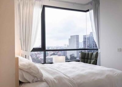 Modern bedroom with large window and city view