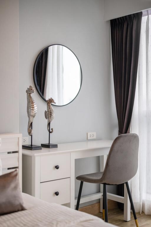 Bedroom with a desk, mirror, and seahorse decorations