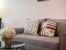 Modern living room with grey sofa and decorative pillows