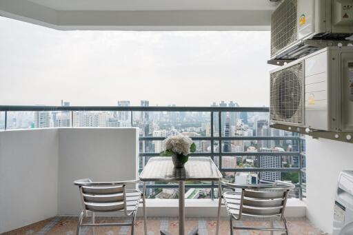 Scenic balcony view with modern seating and cityscape background