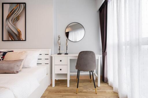 Modern bedroom with a work desk near the window