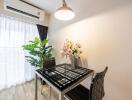 Modern dining area with a glass table and two chairs