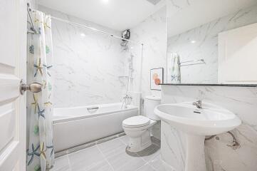 Modern bathroom with bathtub and large mirror