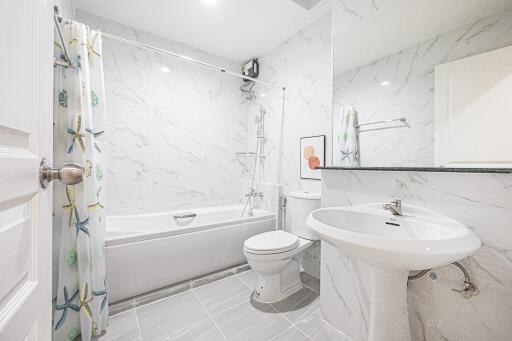 Modern bathroom with bathtub and large mirror