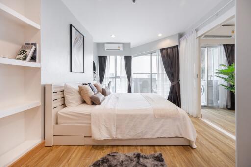 Modern bedroom with hardwood floor and natural lighting