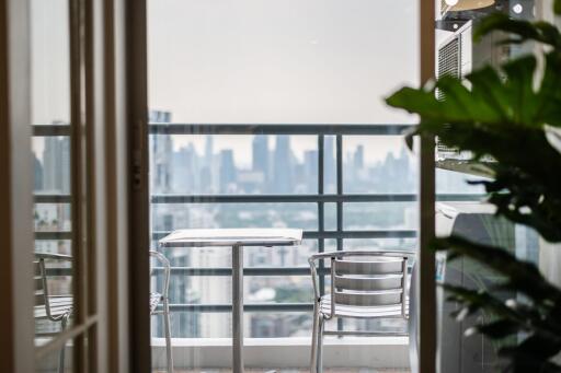 City view balcony with a table and chairs