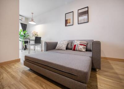 Modern living room with gray sofa and wall art