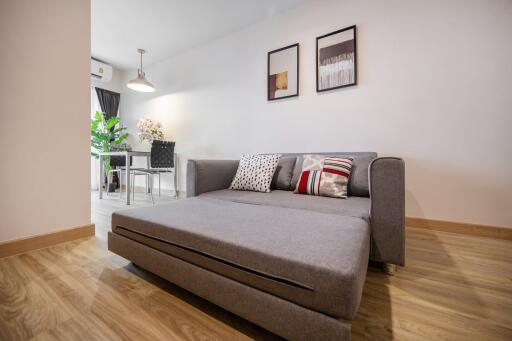 Modern living room with gray sofa and wall art