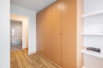 Spacious hallway with wooden cupboards and bookshelves