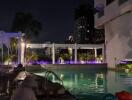 night view of poolside area with lighting