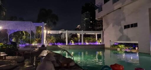 night view of poolside area with lighting