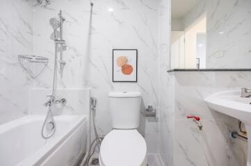 Modern bathroom with white marble walls and fixtures