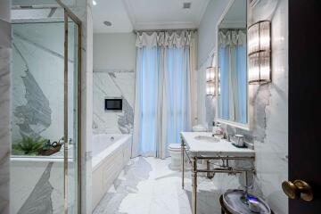 Modern elegant bathroom with bathtub and marble finishes