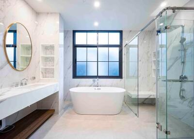 Modern bathroom with standalone tub and glass shower enclosure