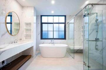 Modern bathroom with standalone tub and glass shower enclosure