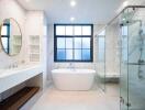 Modern bathroom with standalone tub and glass shower enclosure