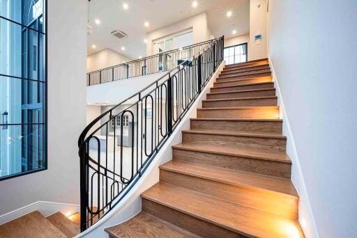 Staircase leading to upper floor with modern railing