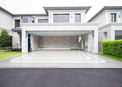 Front view of a modern luxurious house with driveway and garage