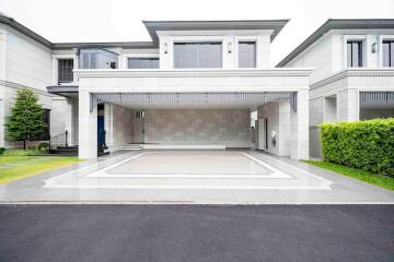 Front view of a modern luxurious house with driveway and garage