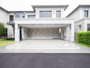 Front view of a modern luxurious house with driveway and garage