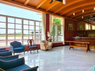 Spacious interior living area with wooden ceiling and large windows