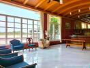 Spacious interior living area with wooden ceiling and large windows