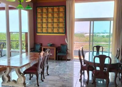 Spacious dining room with wooden ceiling and marble floor