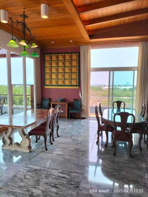 Spacious dining room with wooden ceiling and marble floor