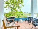 A spacious balcony with seating and a nature view