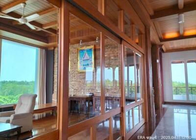 spacious living area with large windows and wooden interiors