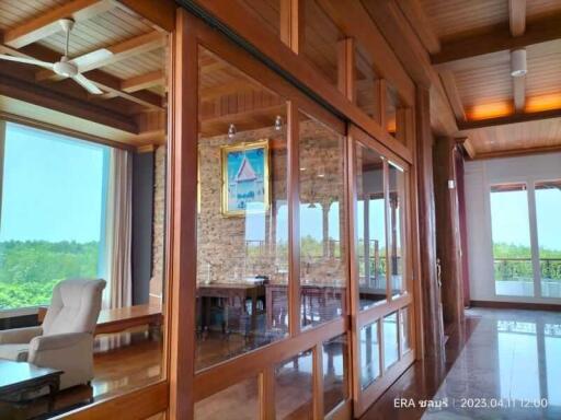 spacious living area with large windows and wooden interiors