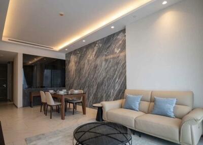 Modern living room with dining area and marble accent wall