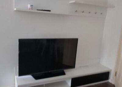 Living room with TV and wall shelves