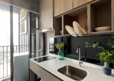 Modern kitchen with sink, counter, and outdoor view