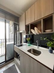 Modern kitchen with sink, counter, and outdoor view