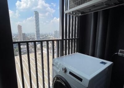 Utility area with a washing machine and a city view