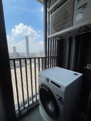 Utility area with a washing machine and a city view