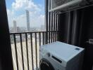 Utility area with a washing machine and a city view