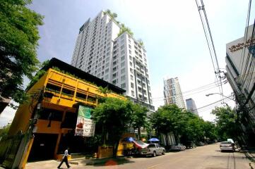 Modern urban buildings with greenery and street view