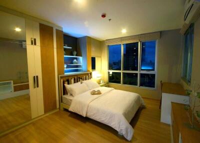 well-lit bedroom with modern furniture