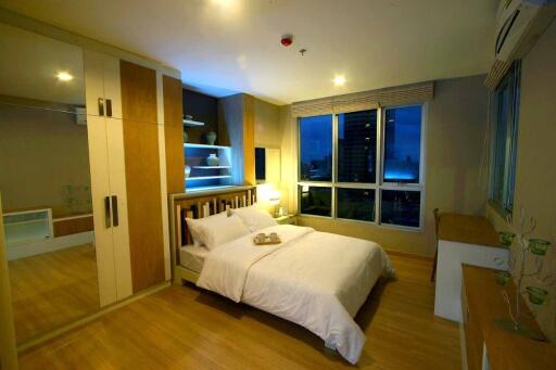 well-lit bedroom with modern furniture